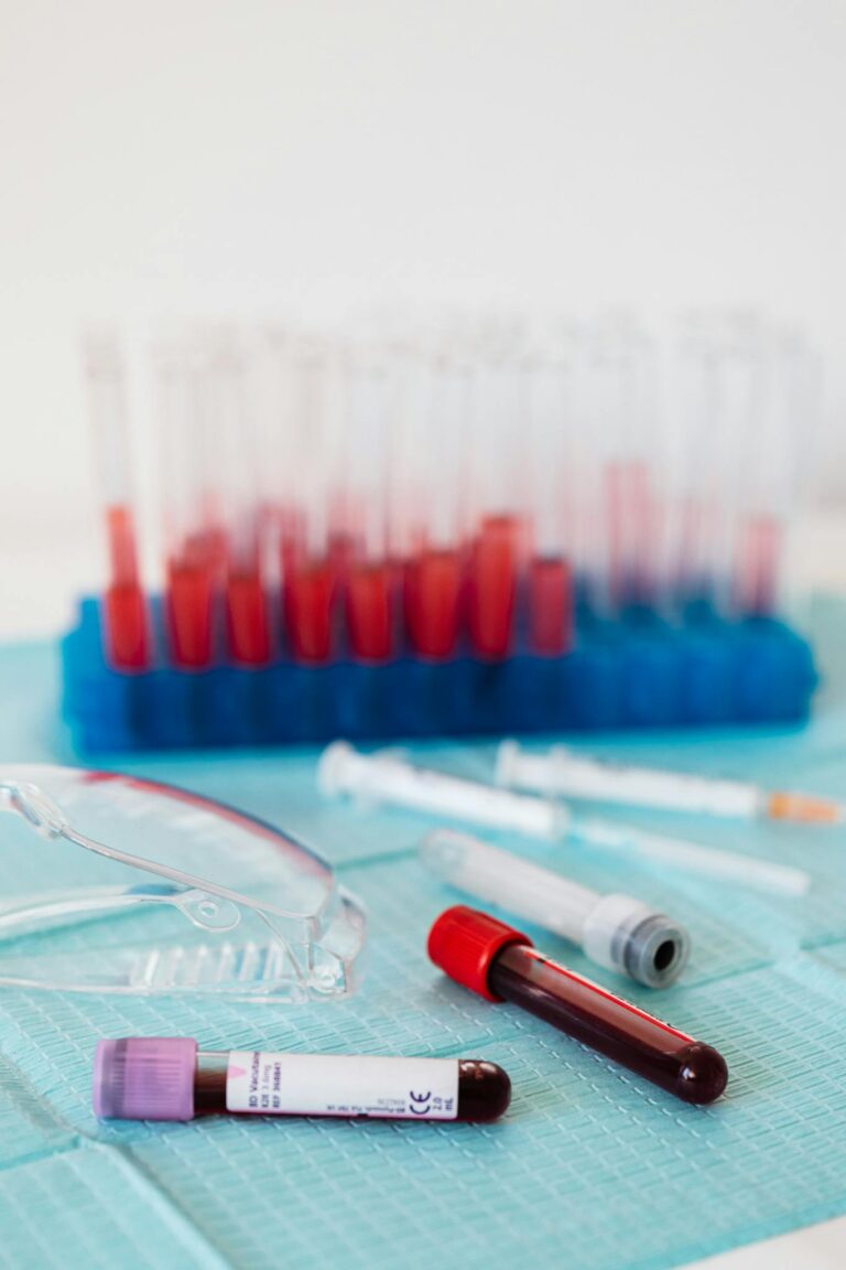 Close-up of blood test tubes and lab equipment in a sterile setting.